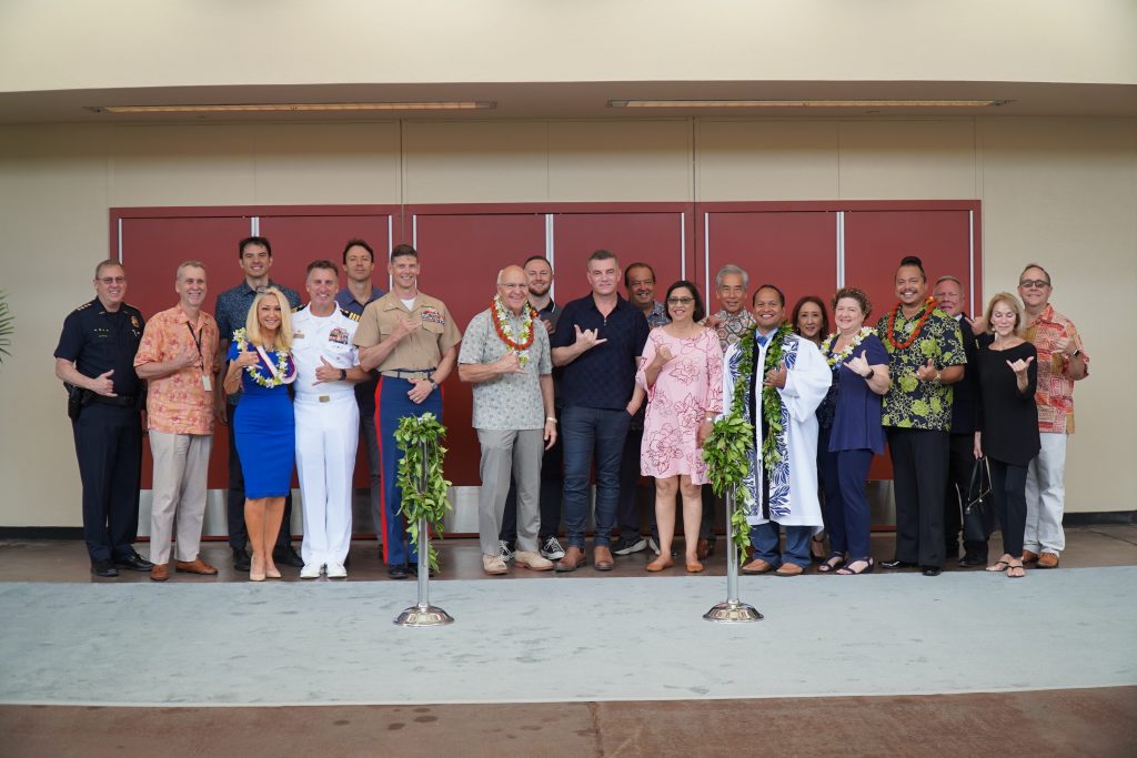 City and military leaders including Honolulu Mayor Rick Blangiardi take a photo outside of the Blaidell Arena. 