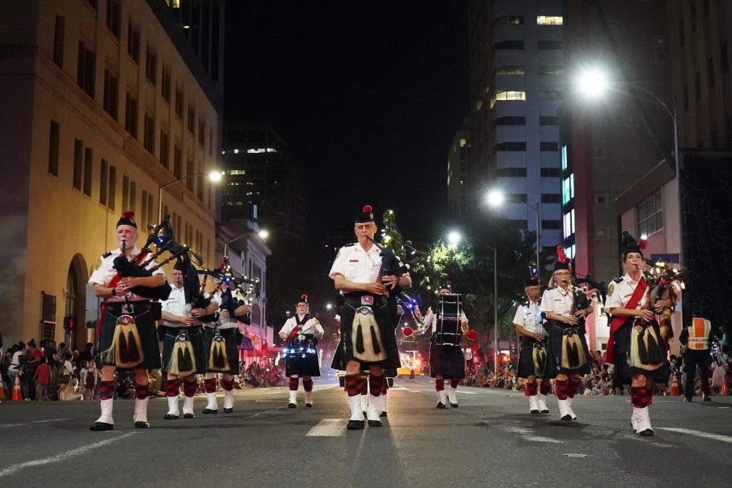 Bagpipers play during the Public Worker's Electric Light Parade during Honolulu City Lights