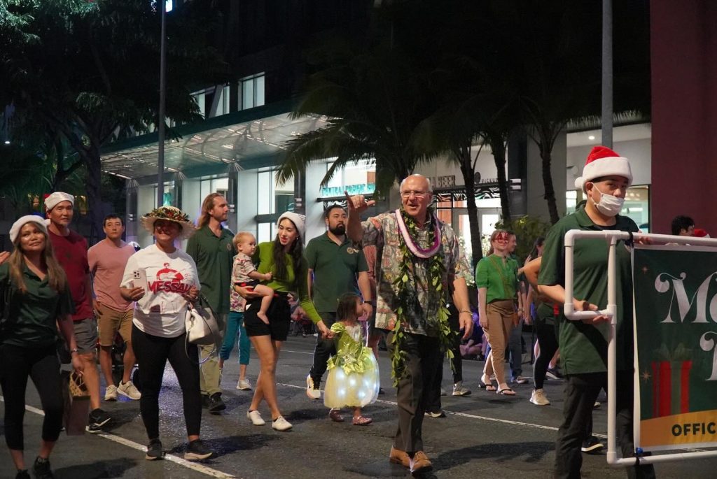 Mayor Rick Blangiardi walks in the Public Worker's Electric Light Parade during Honolulu City Lights