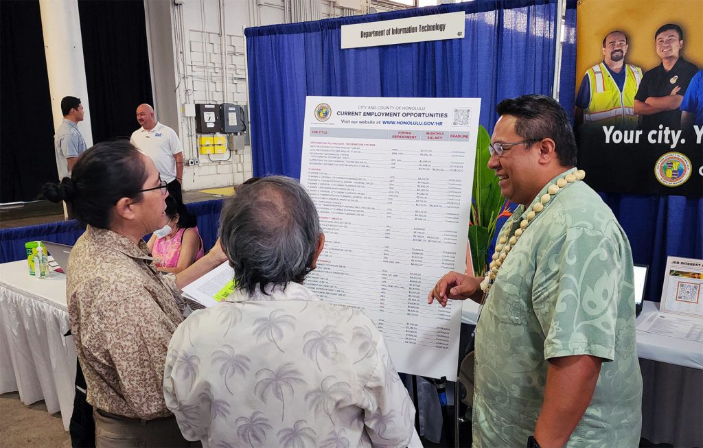 Photo showing City and County of Honolulu representatives during a job fair at the Blaisdell Center.