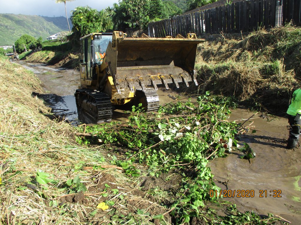 Bulldozer clearing a stream